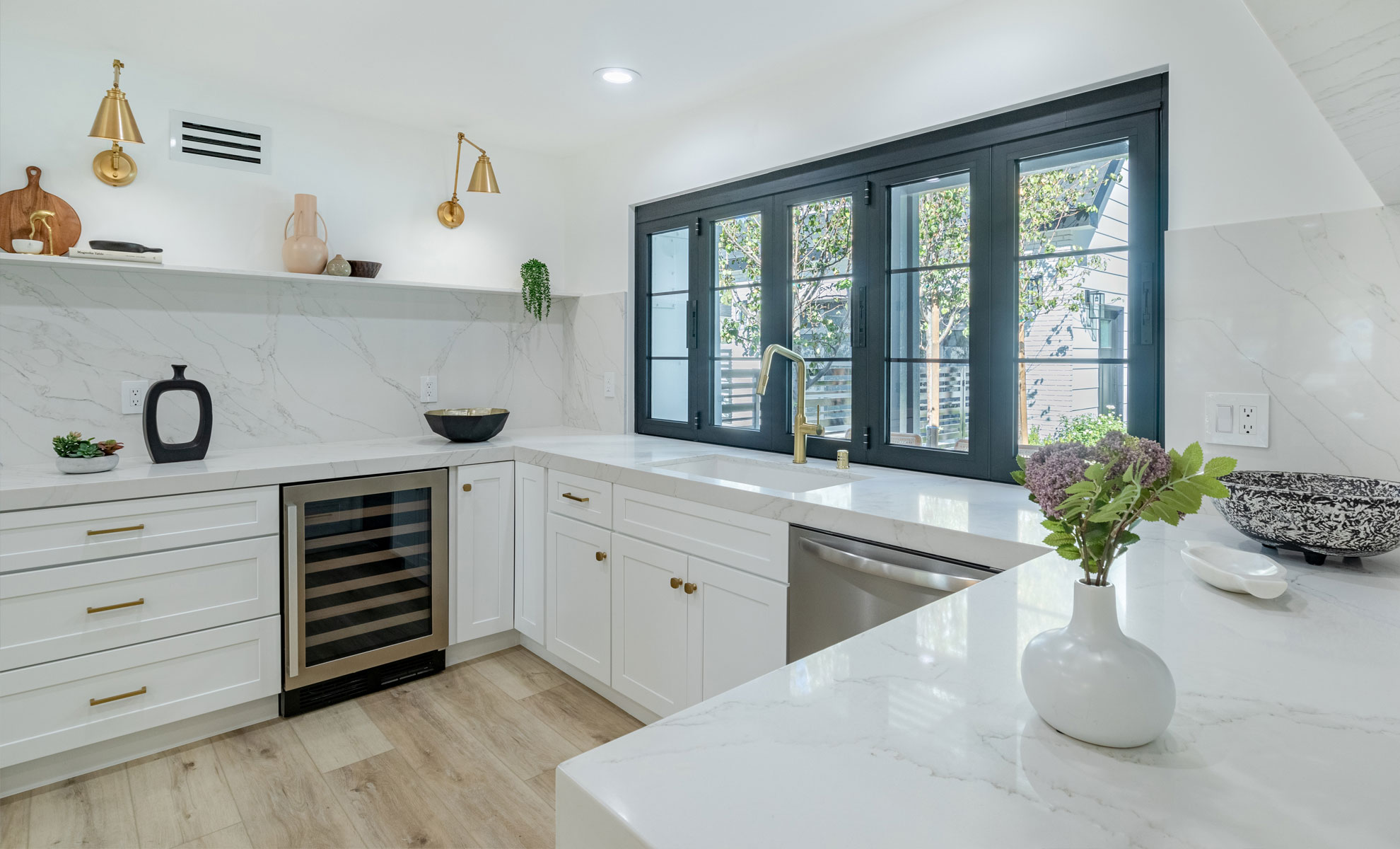 A traditional quartz countertop has beautiful soft gray veining, adding timeless appeal to the kitchen.