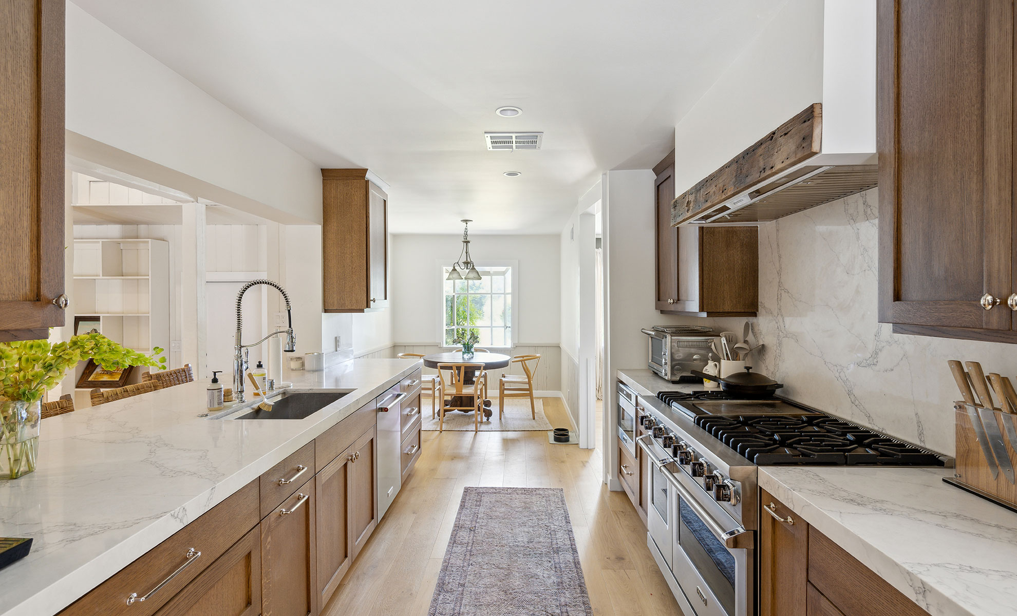 A traditional quartz countertop is paired with wooden cabinetry, creating an inviting atmosphere in the heart of the home.