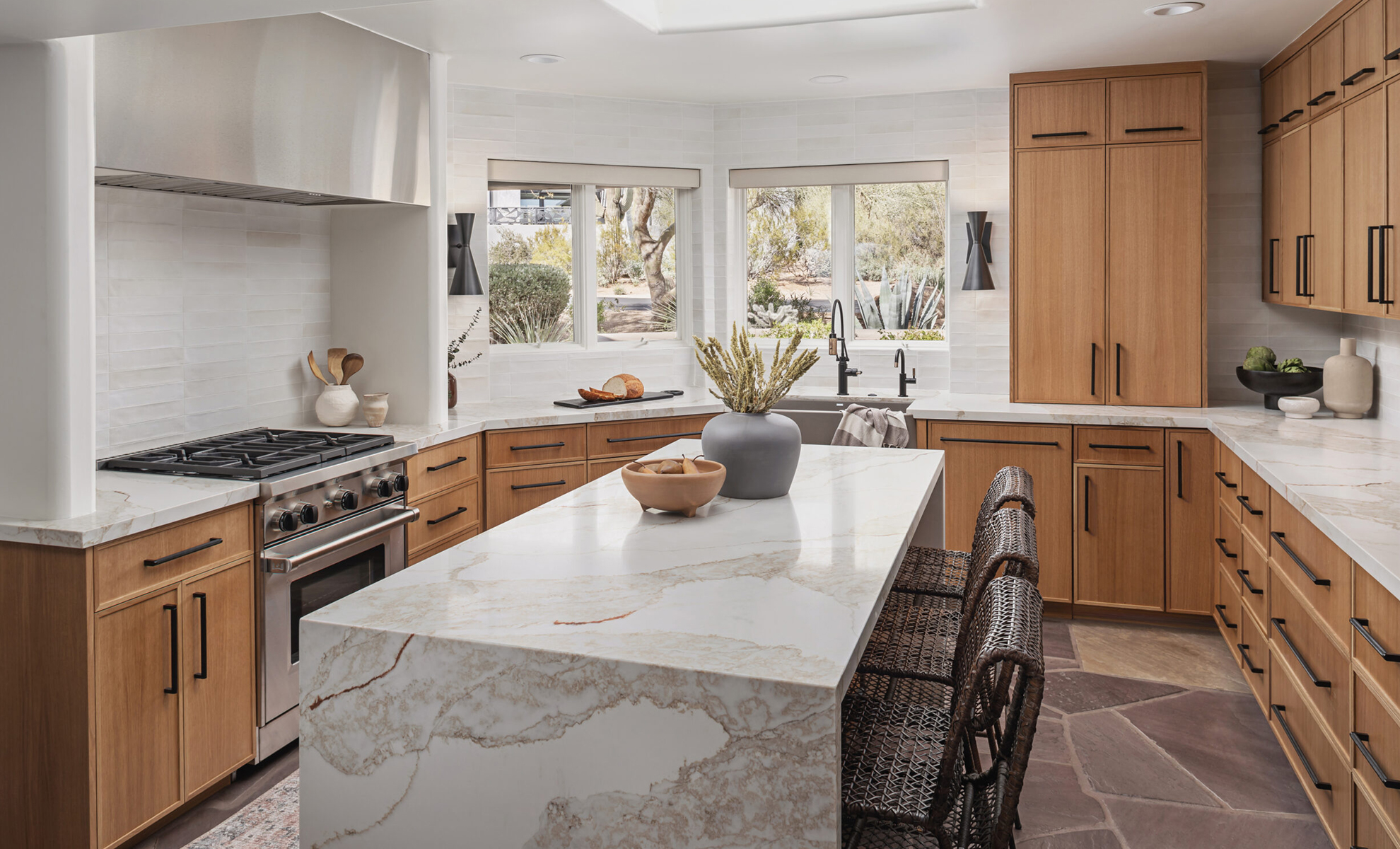 A warm-toned kitchen island has matching countertops The space features natural tones to create a rustic and welcoming space.