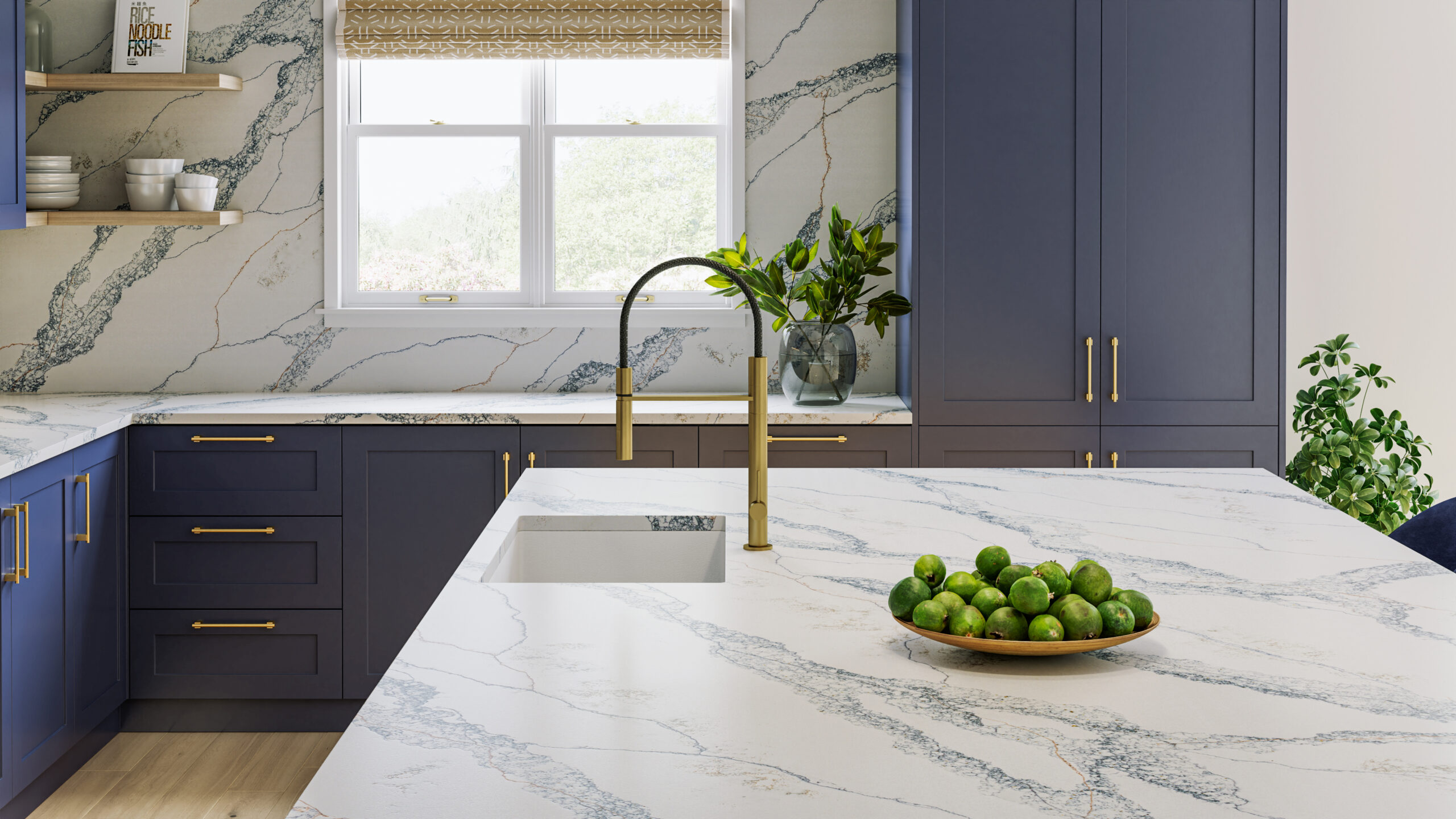 This image depicts a stylish kitchen with a quartz countertop, bold blue cabinetry and elegant gold appliances, creating a chic and modern atmosphere.